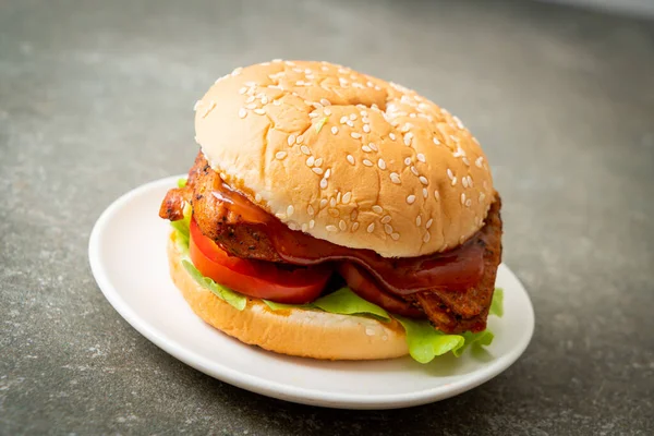 grilled chicken burger with sauce on white plate