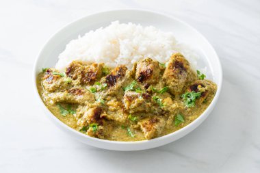Afghani chicken in green curry or Hariyali tikka chicken hara masala with rice - Asian food style