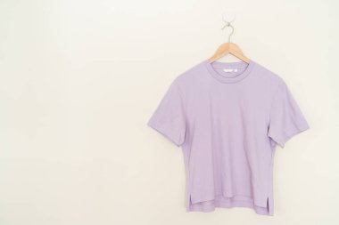 woman t-shirt hanging with wood hanger on wall