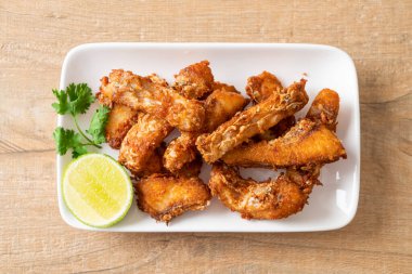 Fried Snapper Belly on white plate - Asian food style