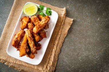 Fried Snapper Belly on white plate - Asian food style