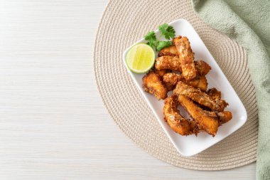 Fried Snapper Belly on white plate - Asian food style