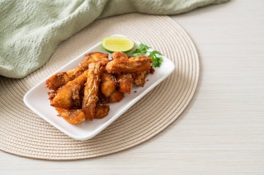 Fried Snapper Belly on white plate - Asian food style