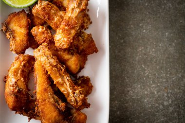 Fried Snapper Belly on white plate - Asian food style