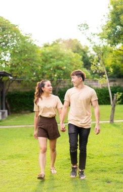 Asian couple love dating and spending time together in park