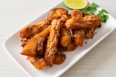 Fried Snapper Belly on white plate - Asian food style
