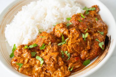 Tavuklu tikka masala, tabakta pilav, Hint yemeği tarzı.