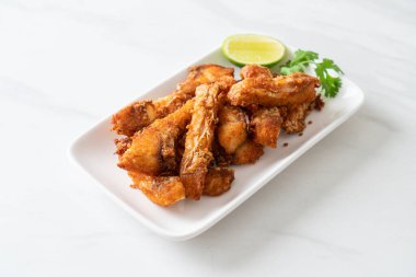 Fried Snapper Belly on white plate - Asian food style