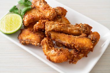 Fried Snapper Belly on white plate - Asian food style