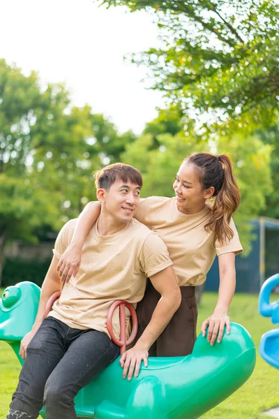 Asian Couple Love Smiling Sitting Rockky Horse Playground — стоковое фото