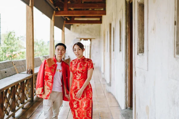 Happy young Asian couple love in Chinese traditional dresses - Red is the main color of the traditional festive that including wedding in China.