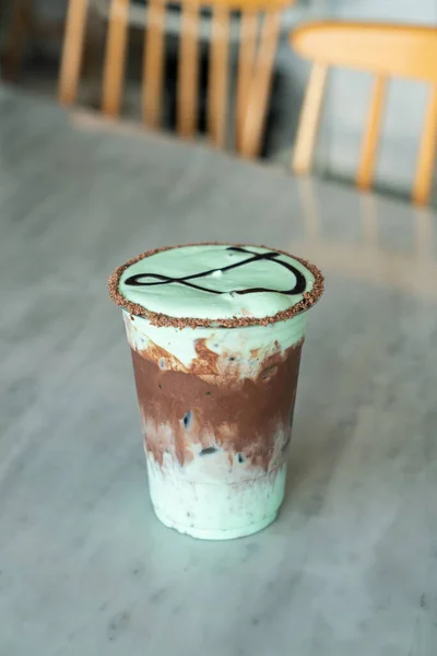 ice chocolate mint milkshake glass on table