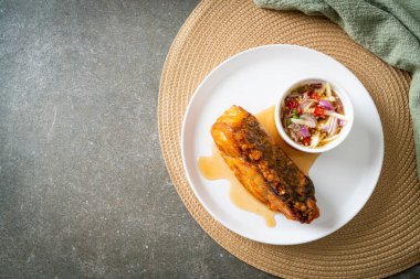 fried snapper fish with fish sauce and spicy salad - Asian food style