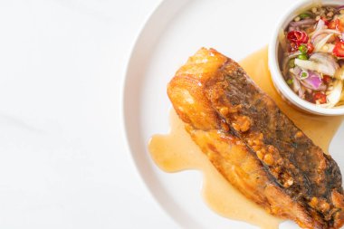 fried snapper fish with fish sauce and spicy salad - Asian food style