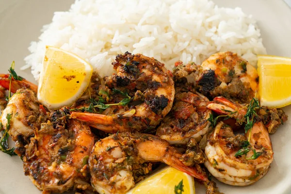 jerk shrimps or grilled shrimps in Jamaica style with lemon and rice