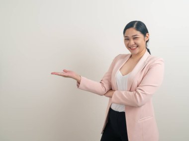 Asian woman with hand presenting on wall