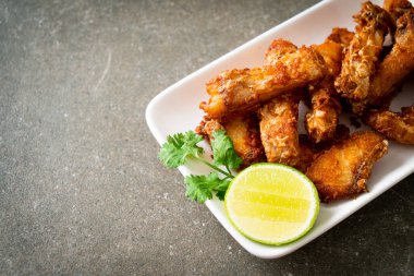 Fried Snapper Belly on white plate - Asian food style