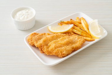 balık ve patates kızartması - kızarmış balık fileto patates cipsi ve limonlu beyaz tabak