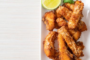 Fried Snapper Belly on white plate - Asian food style