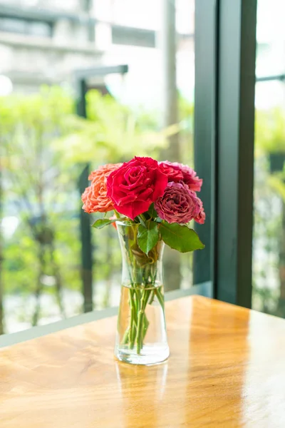 rose flower in vase decoration on wood bar in coffee shop cafe restaurant