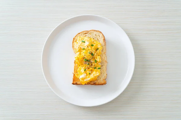 bread toast with scramble egg on white plate
