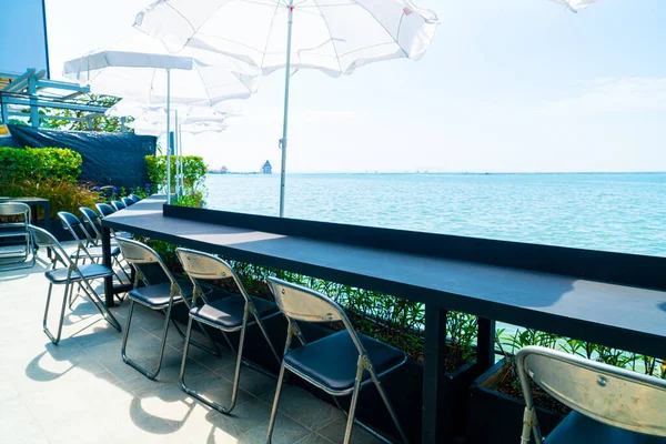 empty outdoor bar and chair with sea background