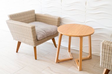 empty wicker sofa with table with white wall