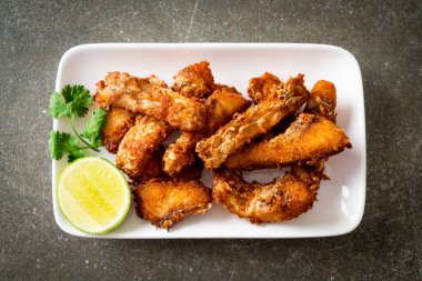Fried Snapper Belly on white plate - Asian food style