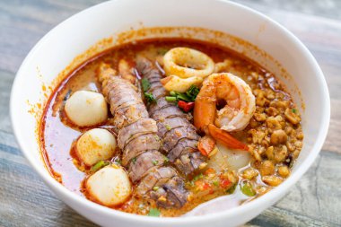 spicy seafood noodles bowl in Thai style - Tom Yum Noodles