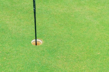 Green and Sand bunkers on Golf course with mountain hill background