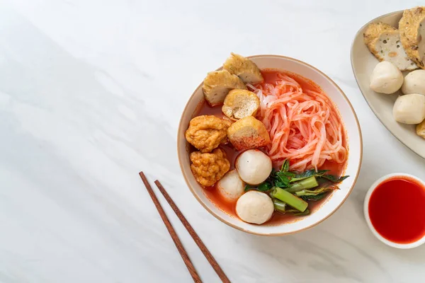 small flat rice noodles with fish balls and shrimp balls in pink soup, Yen Ta Four or Yen Ta Fo - Asian food style