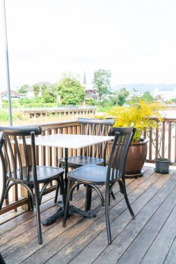 empty table and chair in restaurant with river view