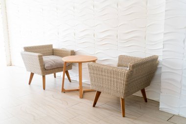 empty wicker sofa with table with white wall