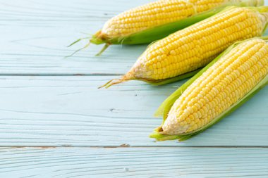 Kopya alanı ile ahşap zemin üzerinde taze mısır
