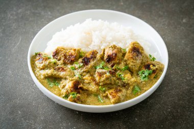 Afghani chicken in green curry or Hariyali tikka chicken hara masala with rice - Asian food style