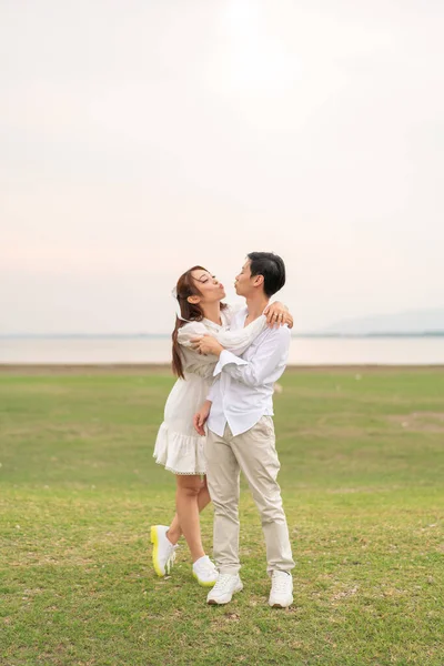 Happy young Asian couple in bride and groom clothing ready for marry and wedding celebrate