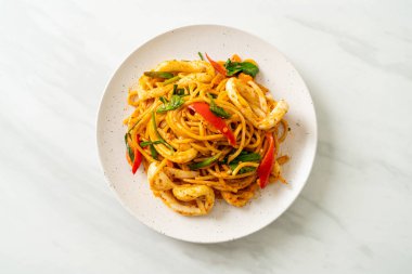 Kızarmış spagetti, tuzlanmış yumurta ve kalamar. Füzyon yemek stili.