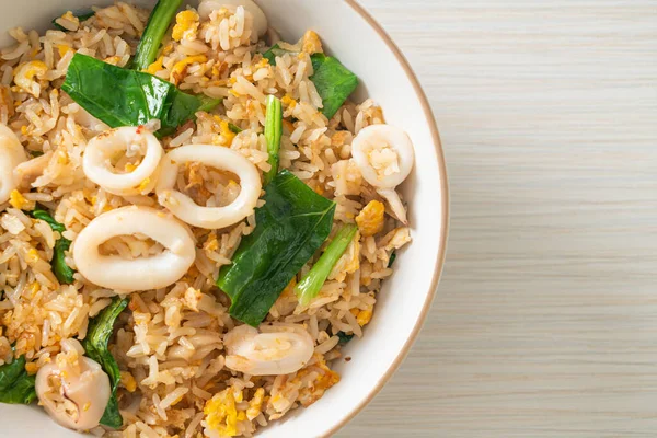 Fried rice with squid or octopus in bowl - stir-fried rice with squid, egg and kale