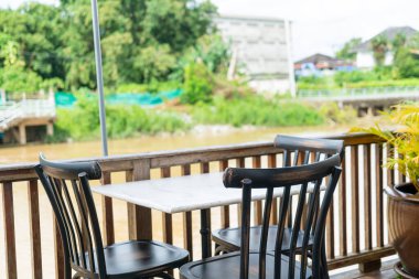 empty table and chair in restaurant with river view