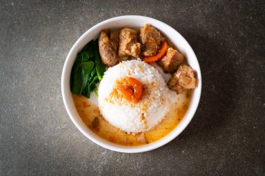 Beyaz tabakta pilav ve domuz pirzolası.