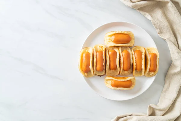homemade flat pancake roll with sausage