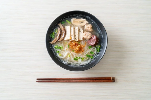 Vietnamese Rice Noodles Soup with Vietnamese Sausage served vegetables and crispy onion - Asian food style