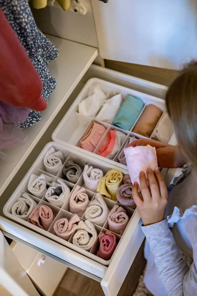 Female hands organizing storage of underwear socks t shirts use Marie Kondos method. Perfectionist Teenage girl — Stock Photo, Image