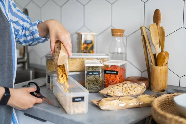 Primer plano manos femeninas colocación y clasificación de pasta en cajas pp. Organización de almacenamiento en la cocina —  Fotos de Stock