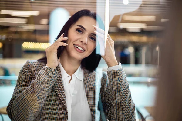 Mujer feliz shopaholic sonriente hablar uso de teléfono inteligente en el centro comercial moderno centro de ocio de fin de semana —  Fotos de Stock