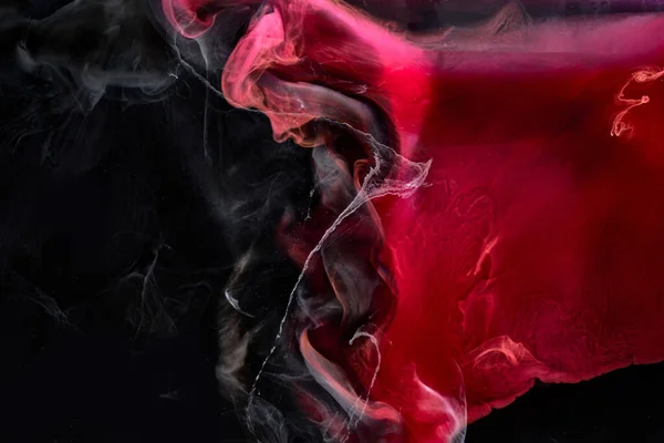 Red black pigment swirling ink abstract background, liquid smoke paint underwater