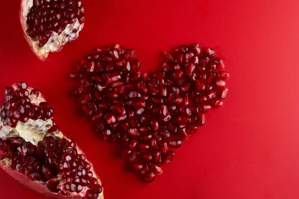 Heart Shaped Juicy Ruby Pomegranate Seeds Isolated Red Background Love — Stock Photo, Image