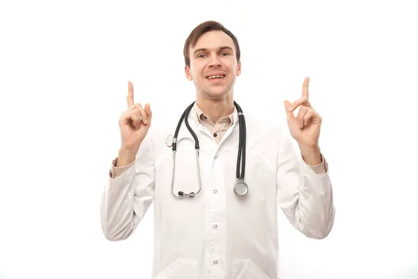 Handsome Doctor White Medical Coat Stethoscope Points Finger Empty Space — Stock Photo, Image