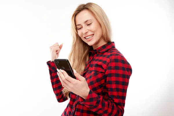 Lucky Smiling Blond Girl Holding Smartphone Casual Isolated White Studio — Stock Photo, Image