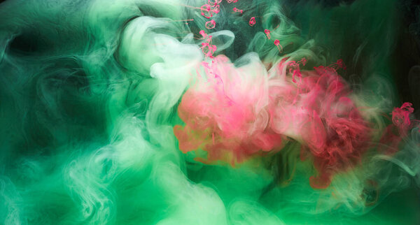 Green pink smoke on black ink background, colorful fog, abstract swirling touch ocean sea, acrylic paint pigment underwater